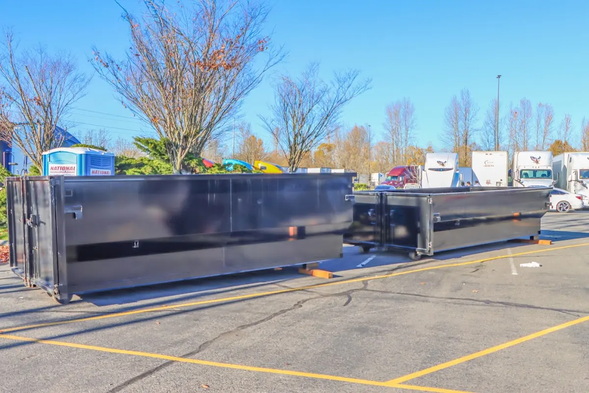 Professional dumpster rental service with roll-off container on residential driveway in El Rio